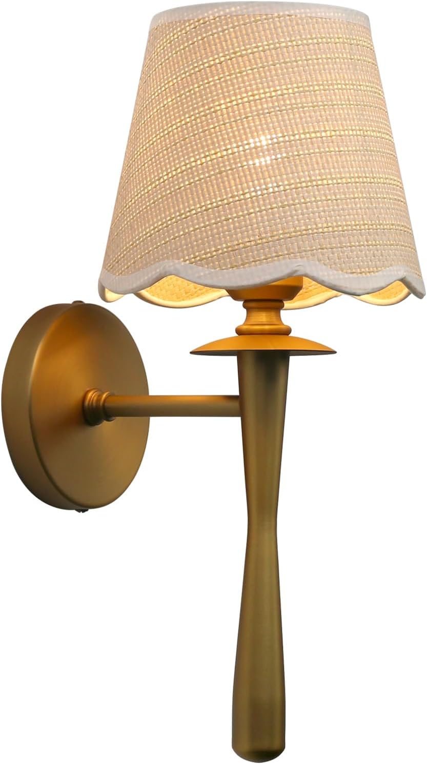 Wall sconce with a textured, scalloped shade and gold-tone arm